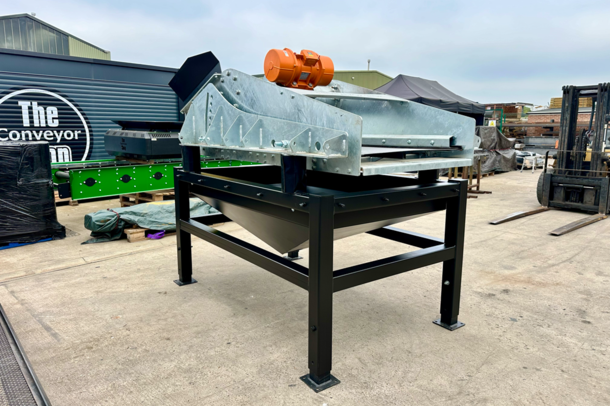 Screener Metal processing equipment on a sturdy black frame in an outdoor setting.